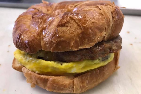 Sausage, egg, and cheese sandwich on crossaint